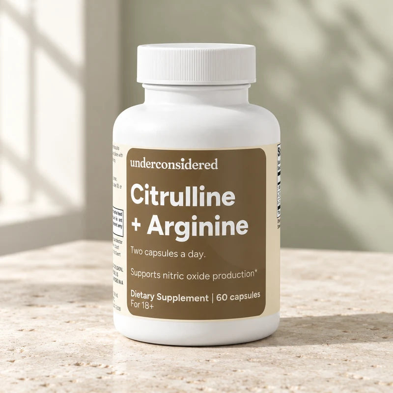 Citrulline and Arginine bottle on pale limestone in daylight